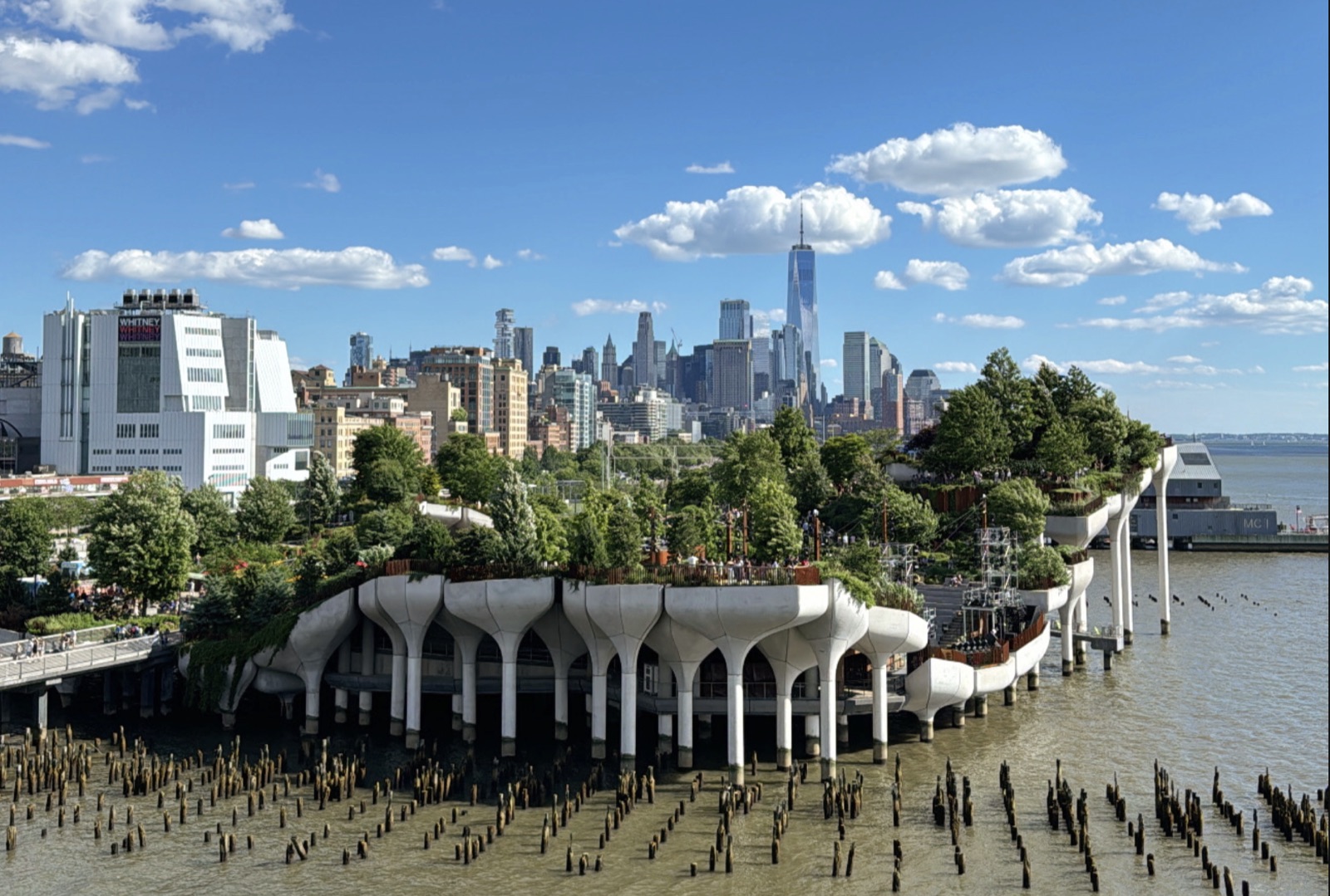 Little Island’s planted concrete piers on the Hudson River with Lower Manhattan and One World Trade Center beyond