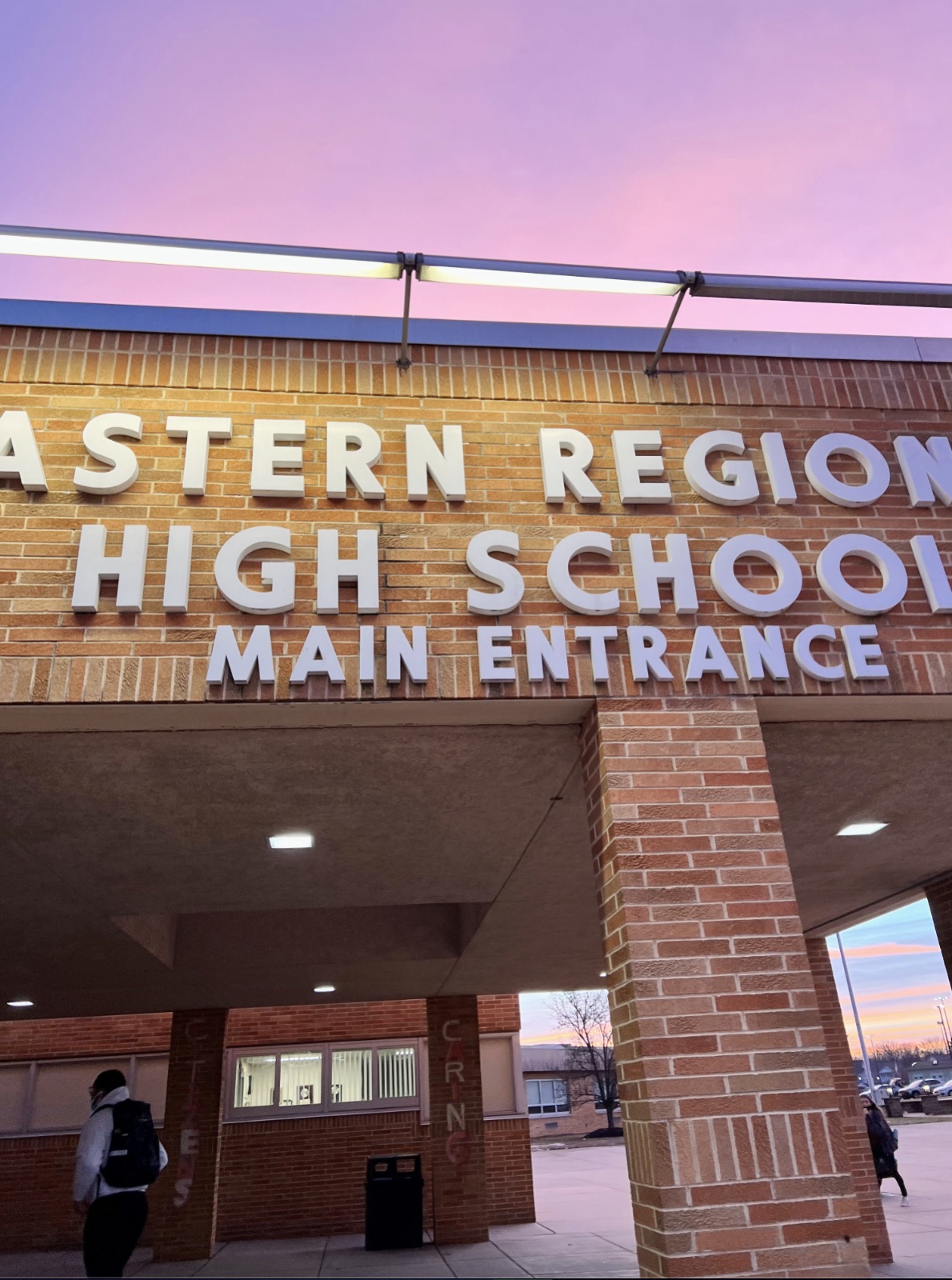 Eastern Regional High School main entrance lettering on a brick facade beneath a pink evening sky